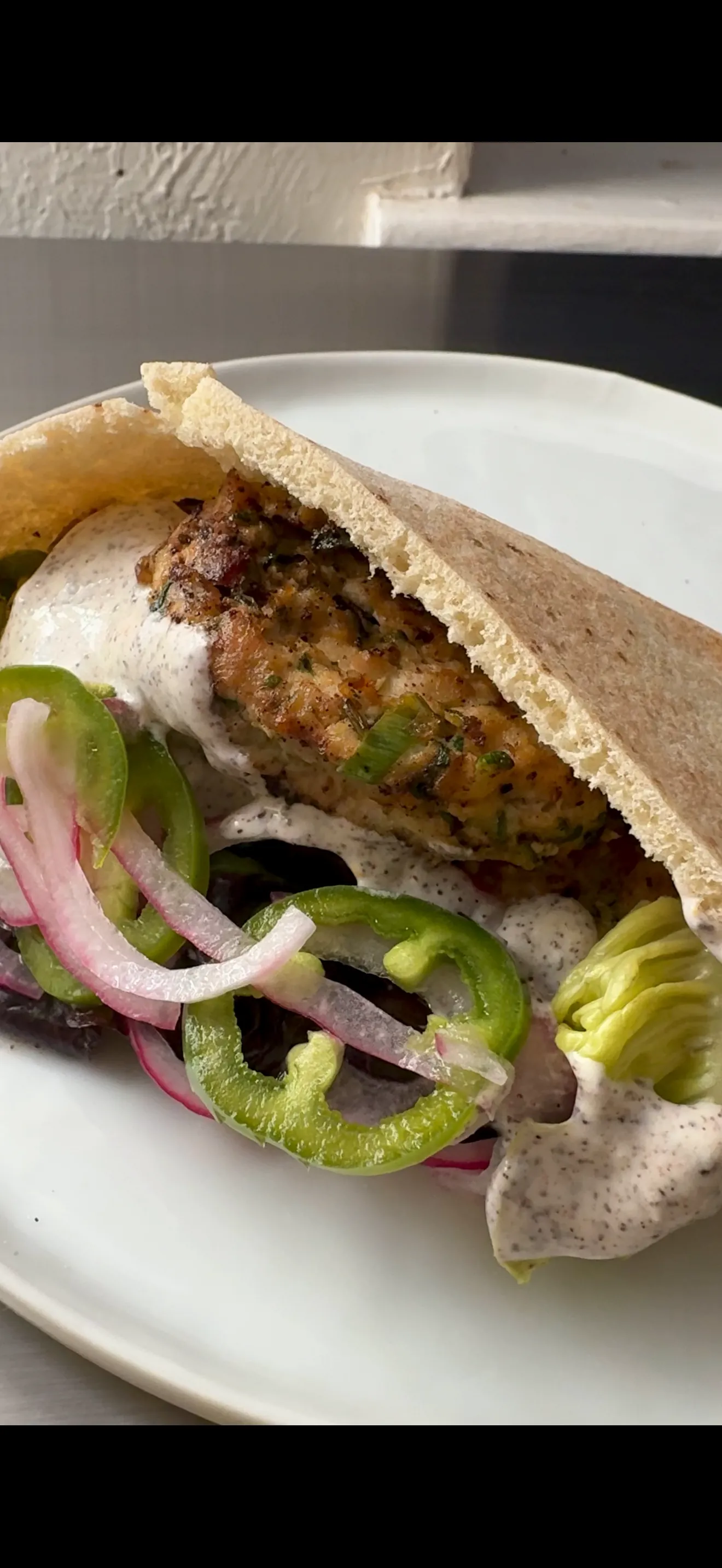 Chicken-zucchini meatballs with little gem lettuce, pita, house pickles, and probiotic ranch.