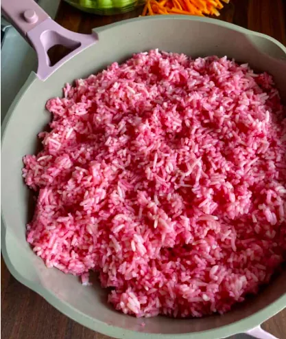 Fluffy pink sushi rice seasoned with rice vinegar and mirin.