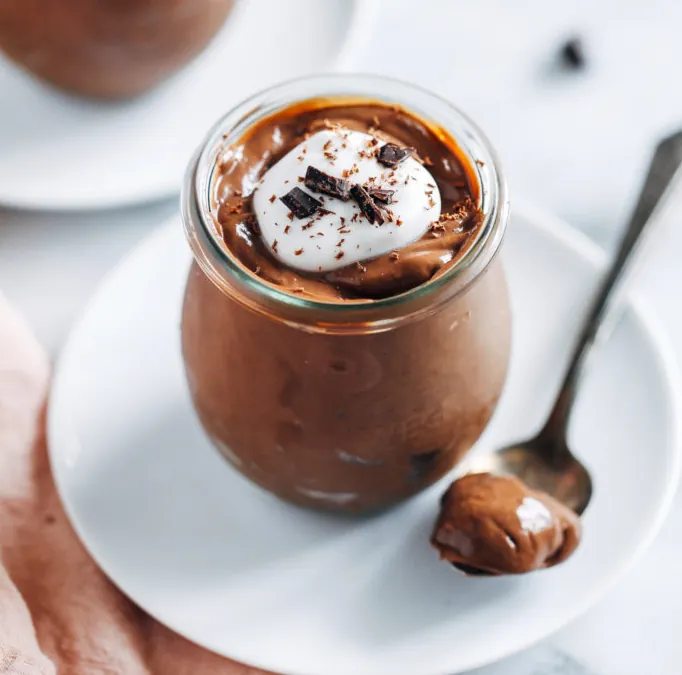 Two individual containers of creamy silken tofu chocolate protein pudding.