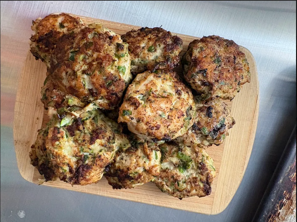 Chicken-zucchini meatballs with green onions, fresh herbs, and garlic.